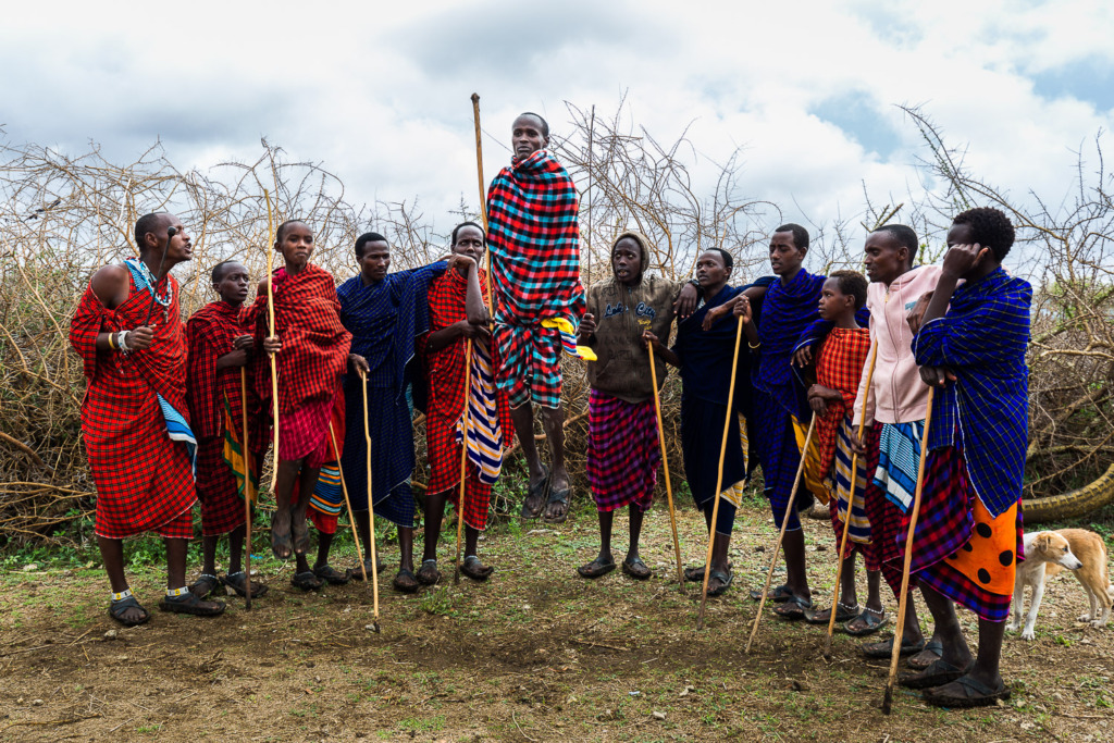shooting action photo of Masai men jumping
