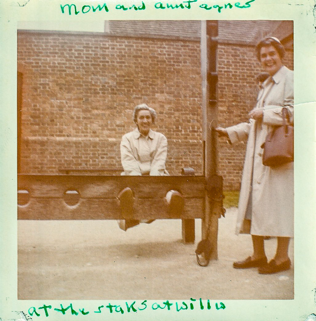 Two women at the stocks in Colonial Williamsburg in the 1950s