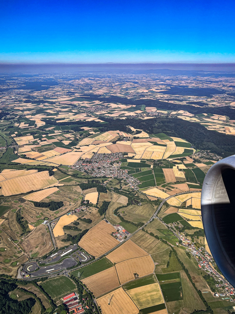 Photo of an aerial view of farmland near Hasselroth, Germany, with an airplane engine in the photo.