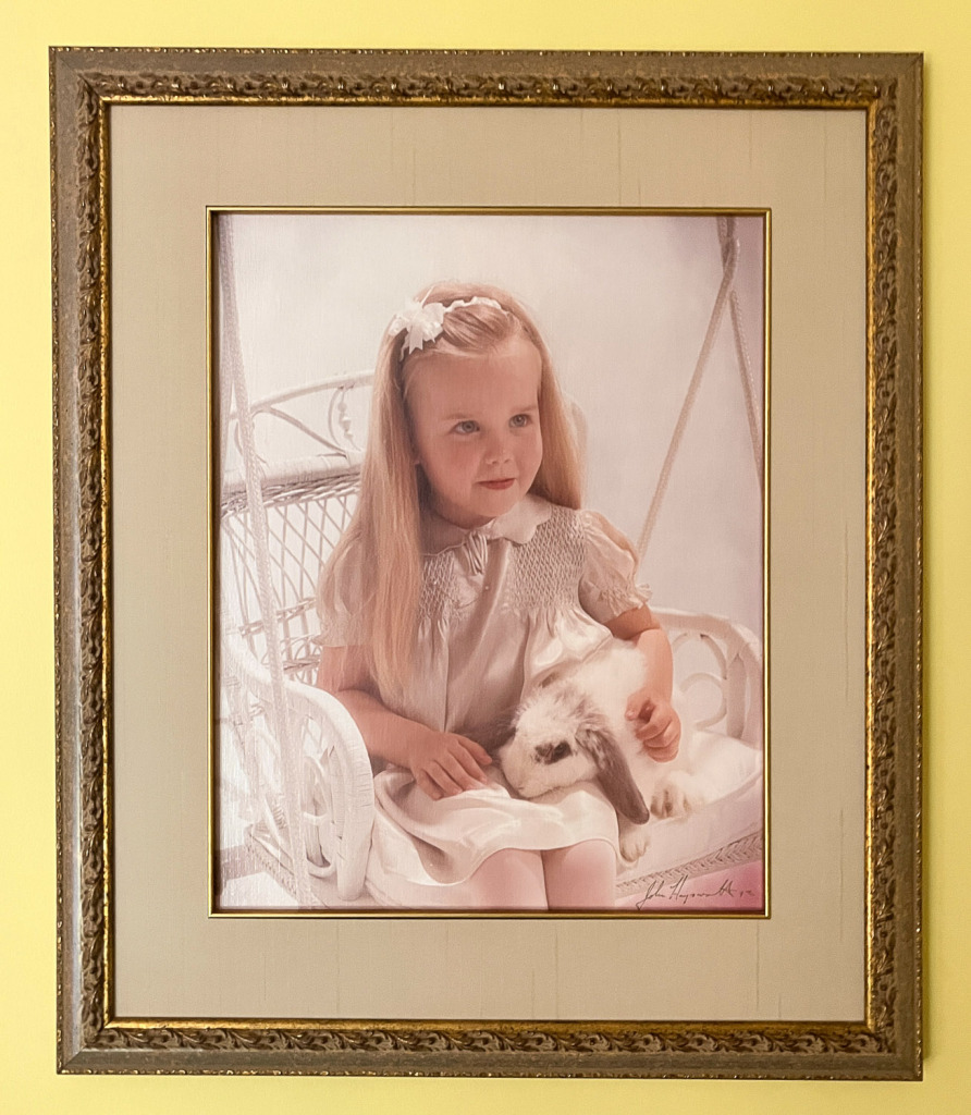 photo on a yellow wall of a photo on canvas of a young girl taken by John Haynsworth