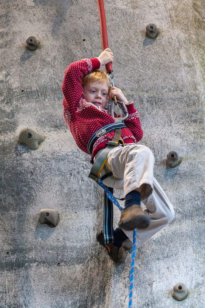 holiday photos of your family should include environmental shots that tell the story like this photo of a boy on a climbing wall
