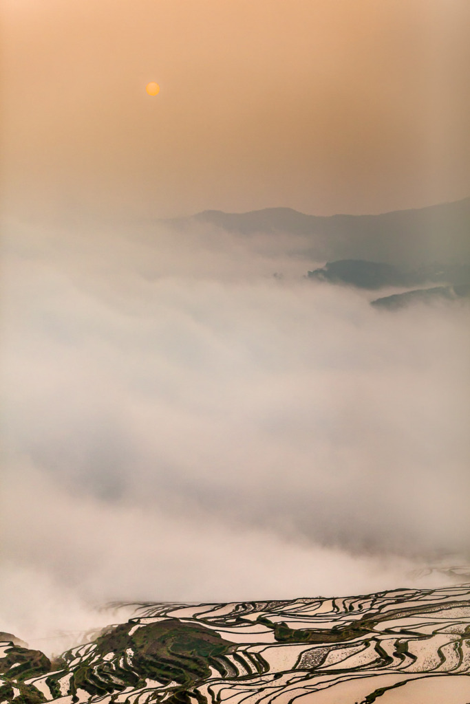 photo in bad weather of Sunrise Above the Yuanyang Rice Terraces with clouds