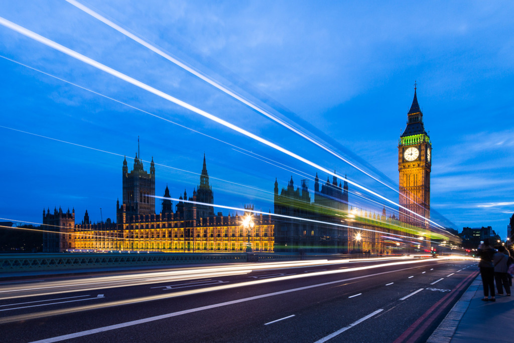 Add movement to your travel photo by shooting a long exposure photo of traffic going across the Westminster Bridge in London with Big Ben lit up in the background..