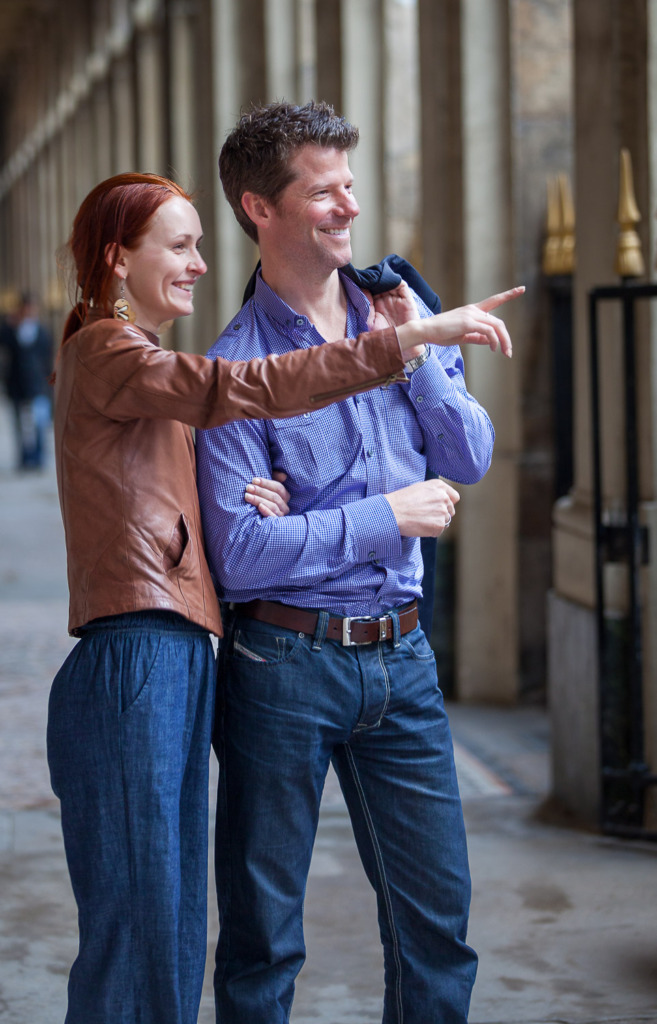 Photo of a young couple pointing.