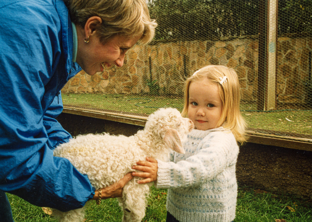 You'll have photos to share, like this one of a mother and daughter holding a baby goat, when you digitize your photos and videos.