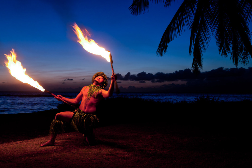 Your travel photos can be exciting if you include flames like the ones in this photo of a Hawaiian fire dancer at sunset.