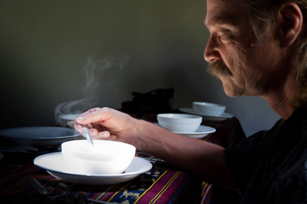 Creative storytelling photo of a man savoring his hot soup in Cotacachi, Ecuador.