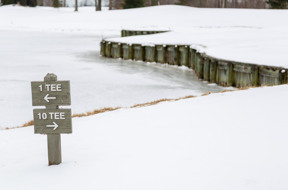 Shooting this snow photo of a sign at a golf course was taken with +2 exposure compensation to make the snow around it bright.